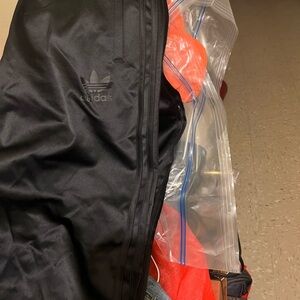 Addias detached black glossy paints. New with tag